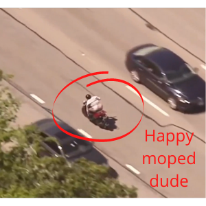 Man on moped driving wrong way on highway